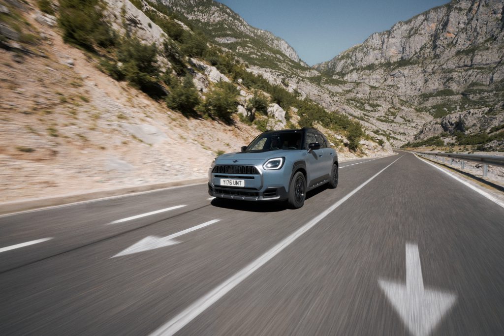 MINI Countryman u vožnji planinskim putem okružen stenama