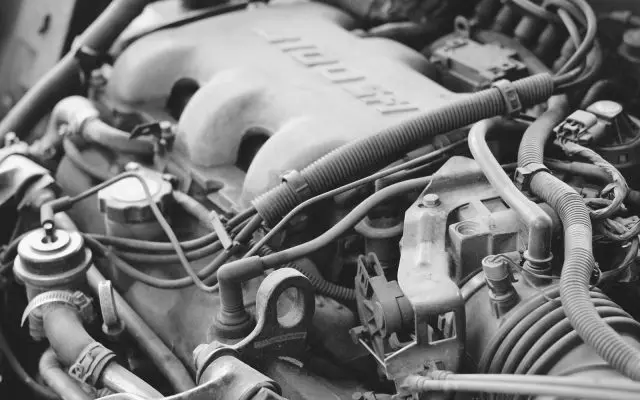 Detalj motora automobila ispod haube sa crevima i kablovima rashladnog i električnog sistema